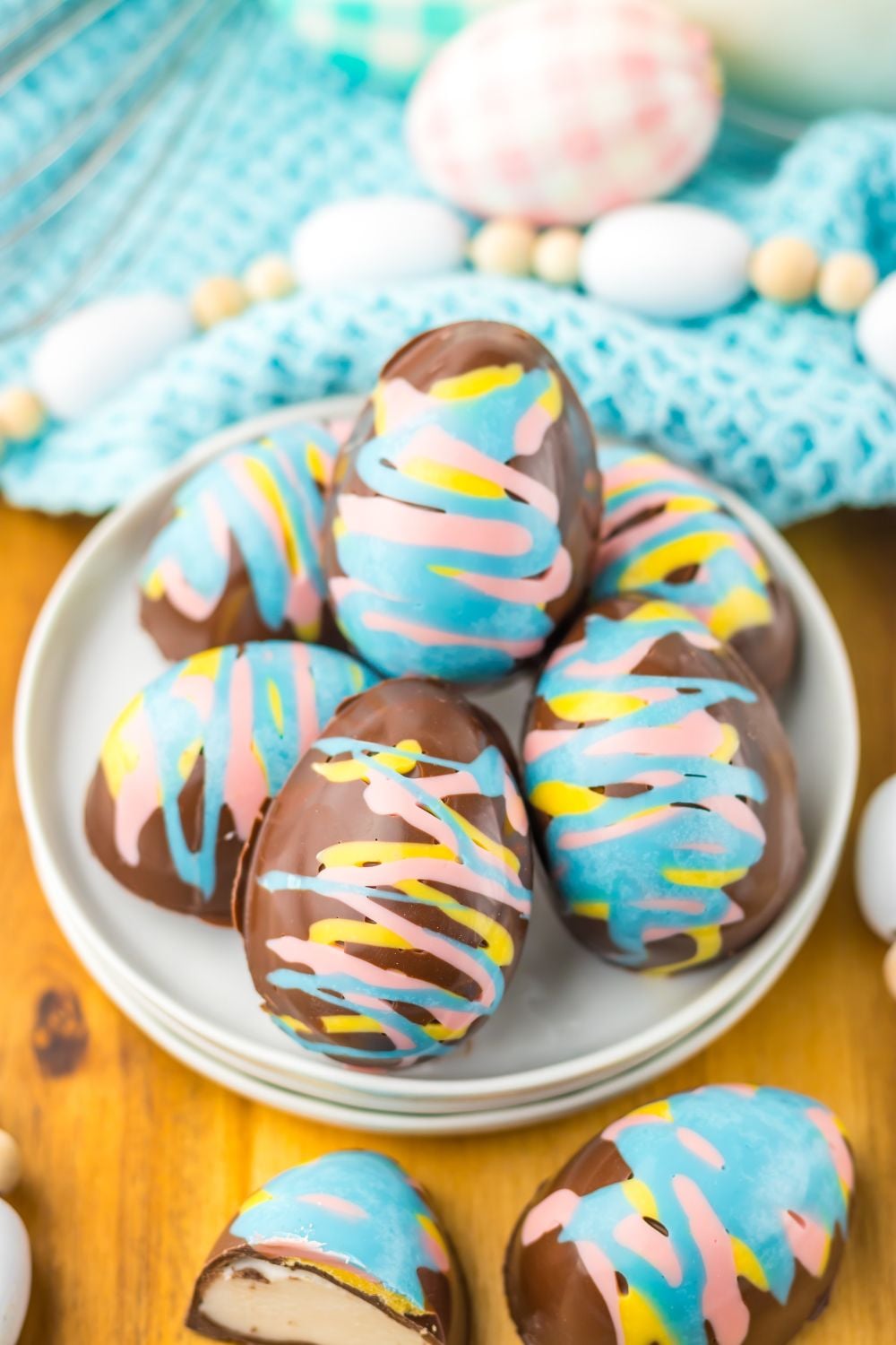 Easter Marshmallow Eggs stacked on a plate and candies around it 