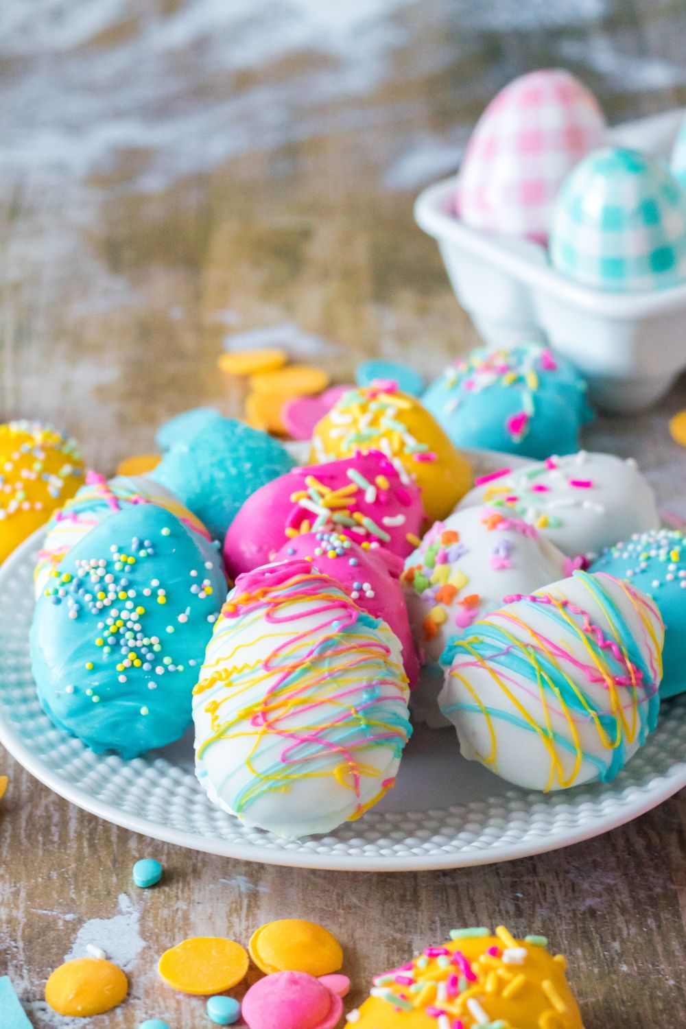 Easter Egg Oreo Truffles on a table with Easter decorations around the table