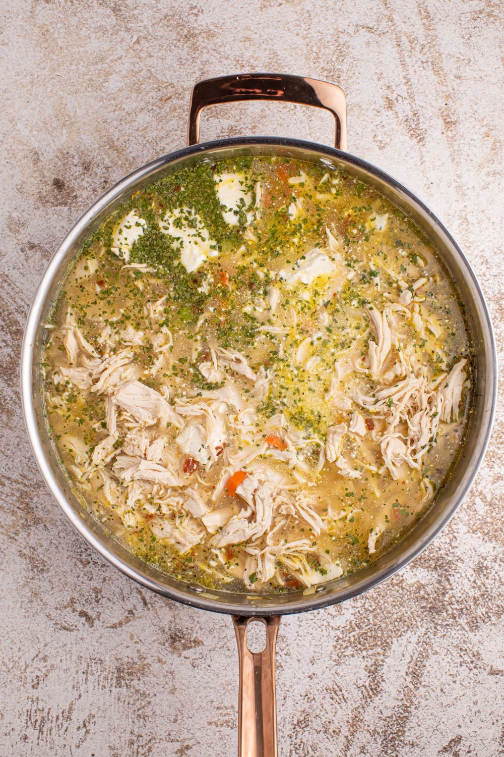 mixing up Crack Chicken Soup ingredients in a metal pan on table