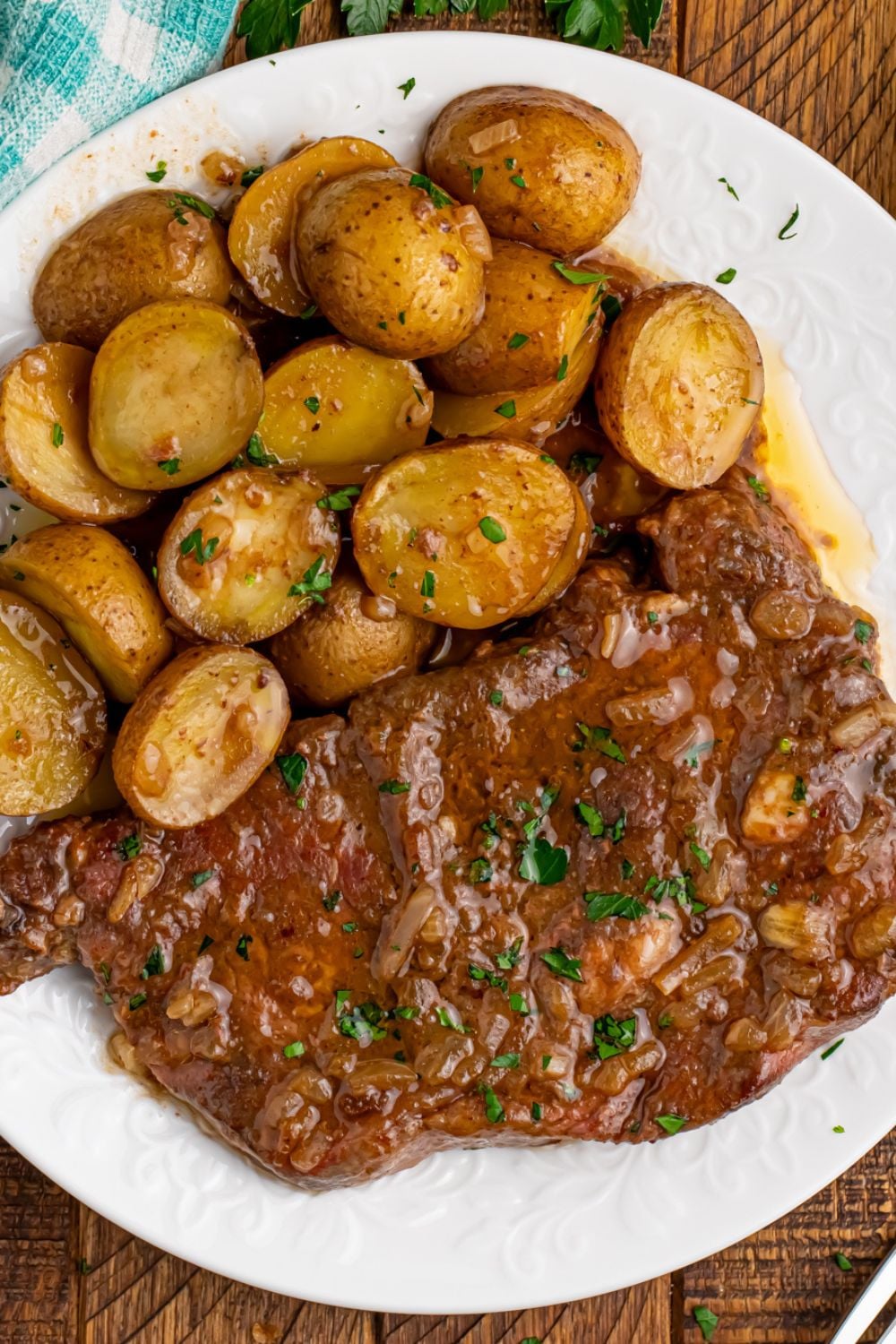 plate with meat and potatoes on it from the Crock Pot Steak and Potatoes