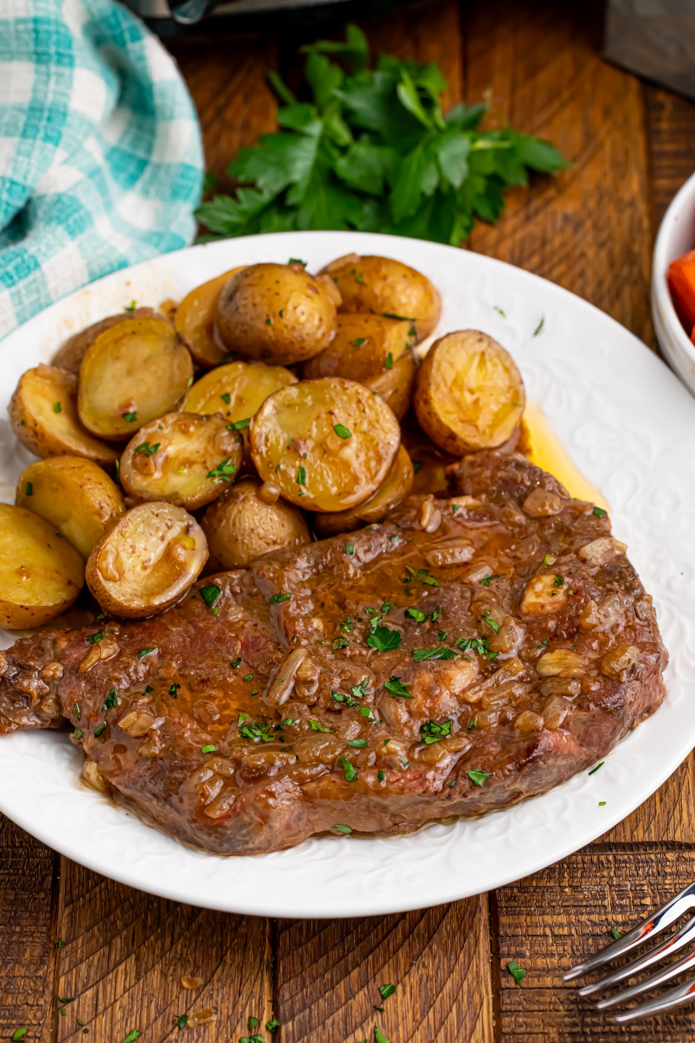 plate with meat and potatoes on it from the Crock Pot Steak and Potatoes