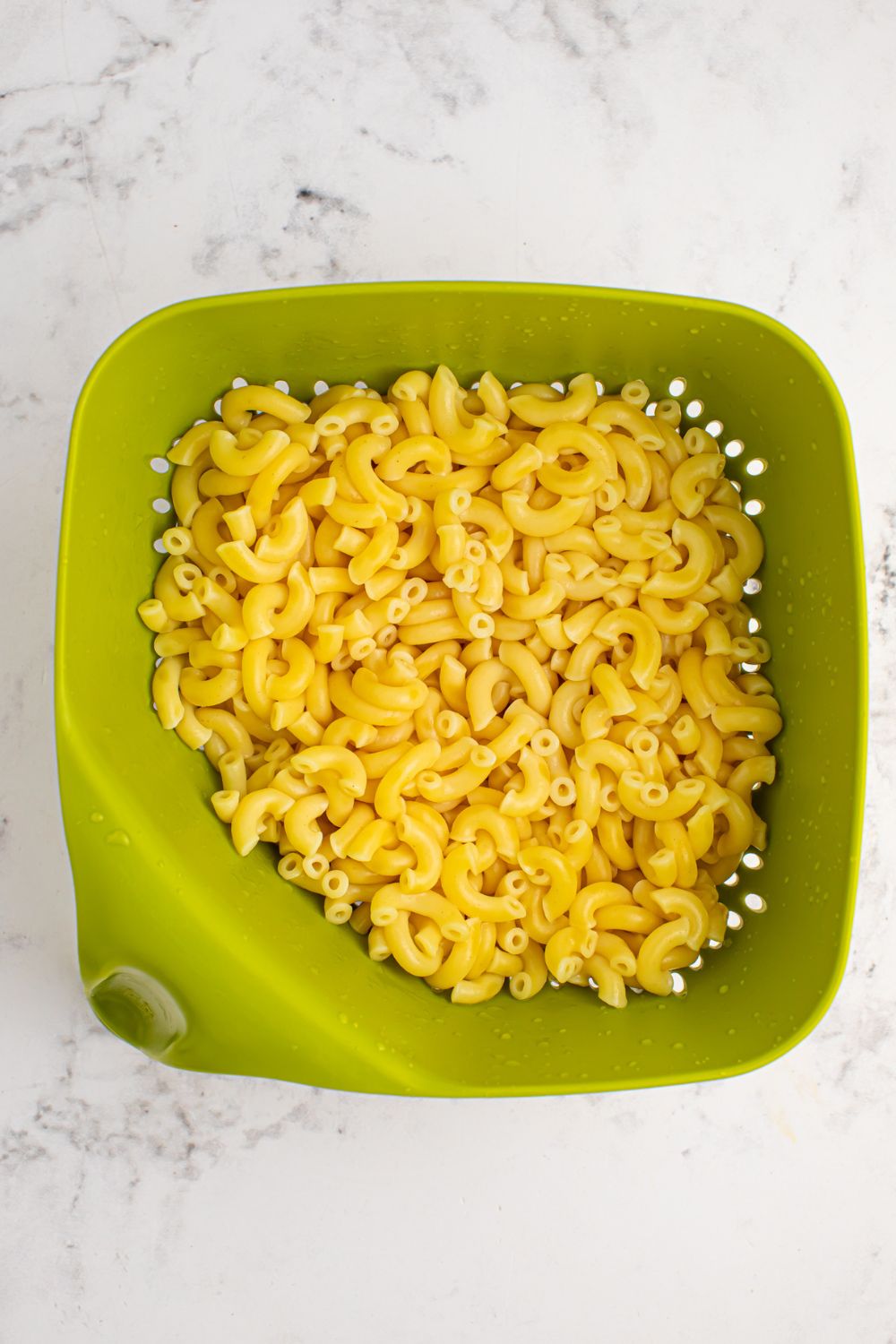 pasta in a strainer sitting on table