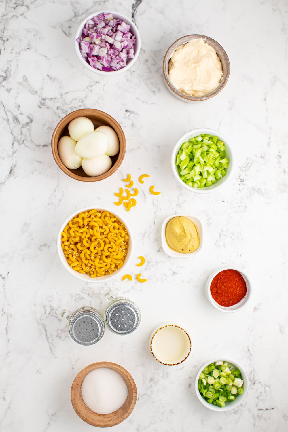 ingredients for Deviled Egg Pasta Salad in single serve bowls on table