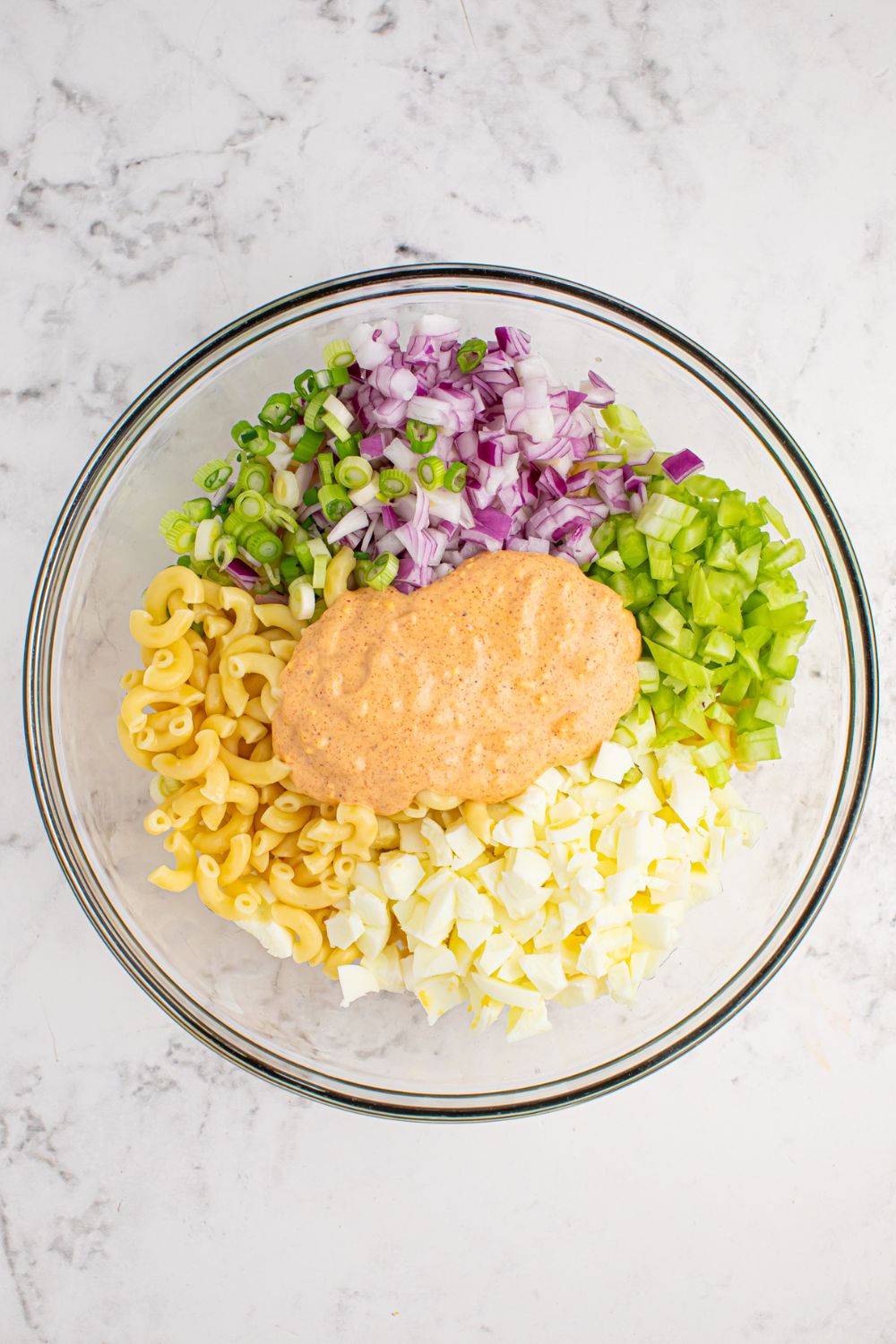 ingredints for the Deviled Egg Pasta Salad in a glass bowl