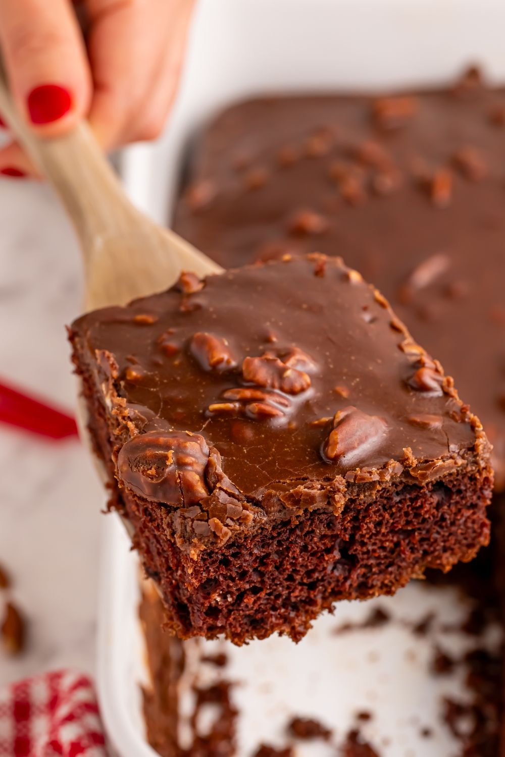 Dr. Pepper Cake in pan with a slice being lifted out with a spatula