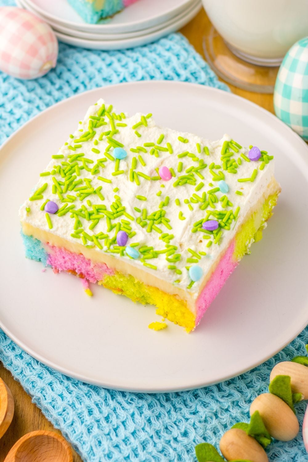 Easter Poke Cake on plat with Easter decor around it on table