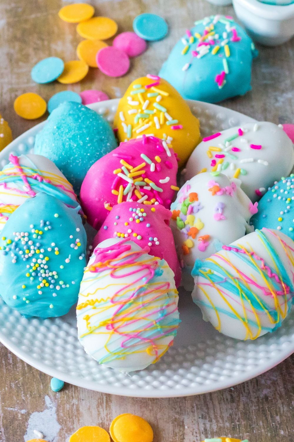 Easter Egg Oreo Truffles on a plate with candy melts around it on table