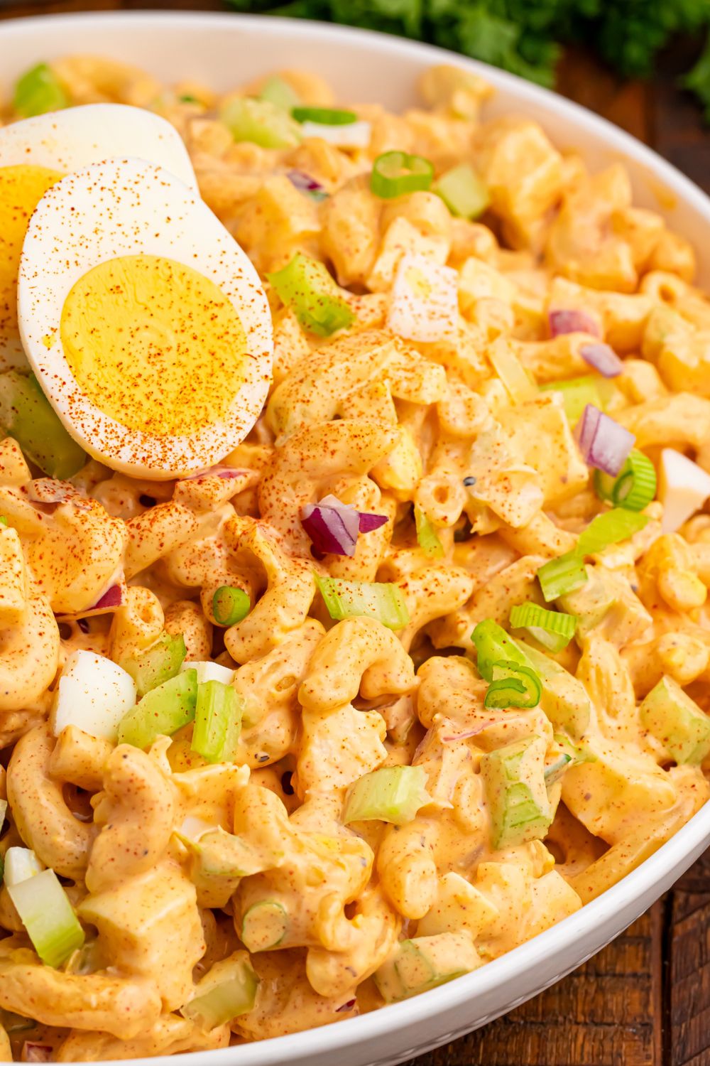 deviled egg pasta salad with a hard boiled egg placed on top