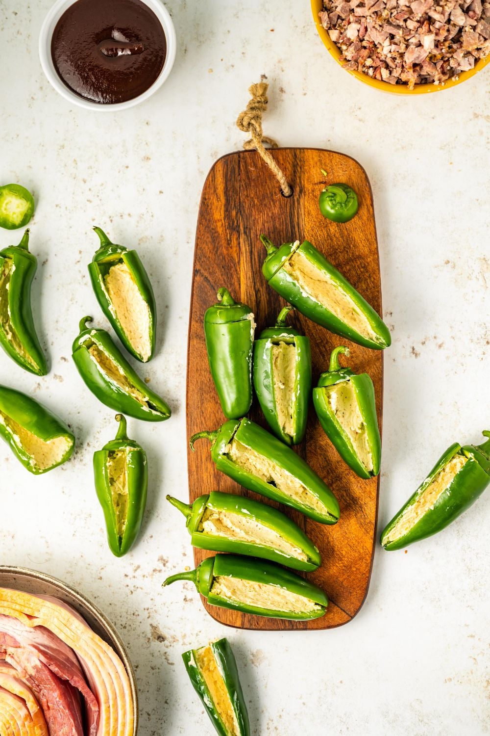 jalapeno peppers sliced aand placed on a wooden cutting board on table