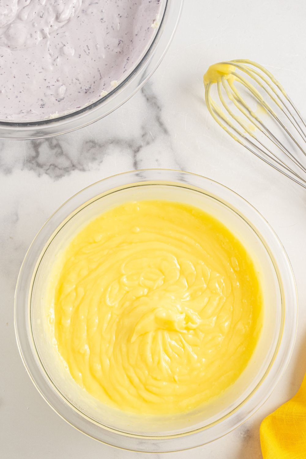 lemon pudding layer mixed up in a bowl on marble table for Lemon Blueberry Lush