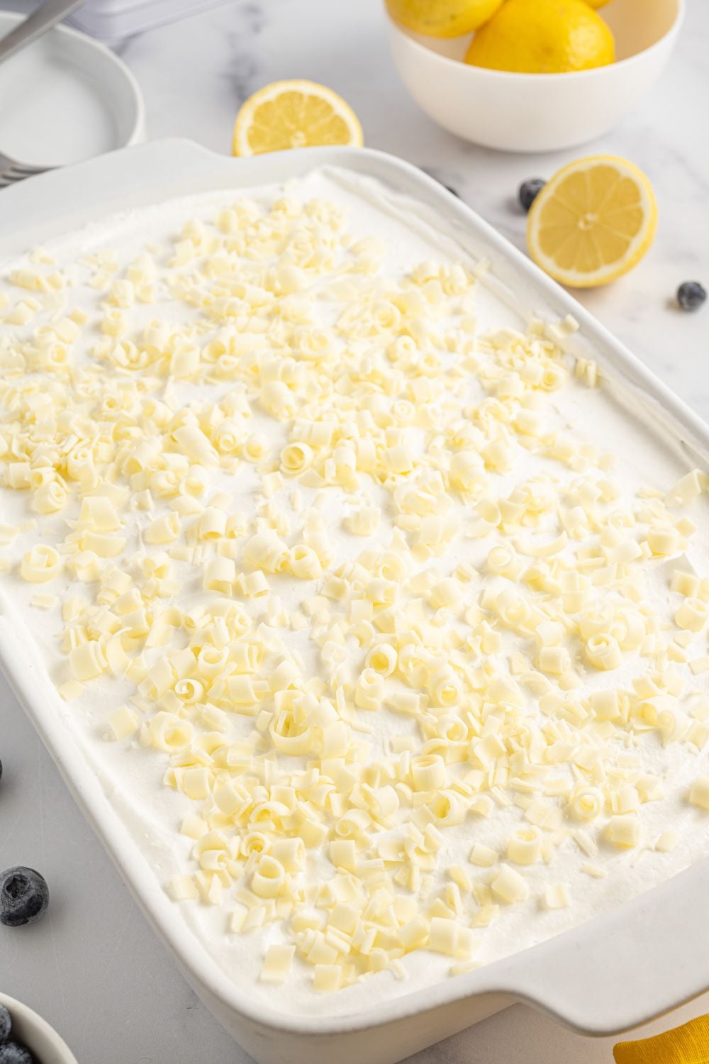 white chocolate shavings sprinkld over the top of he Lemon Blueberry Lush sitting on table