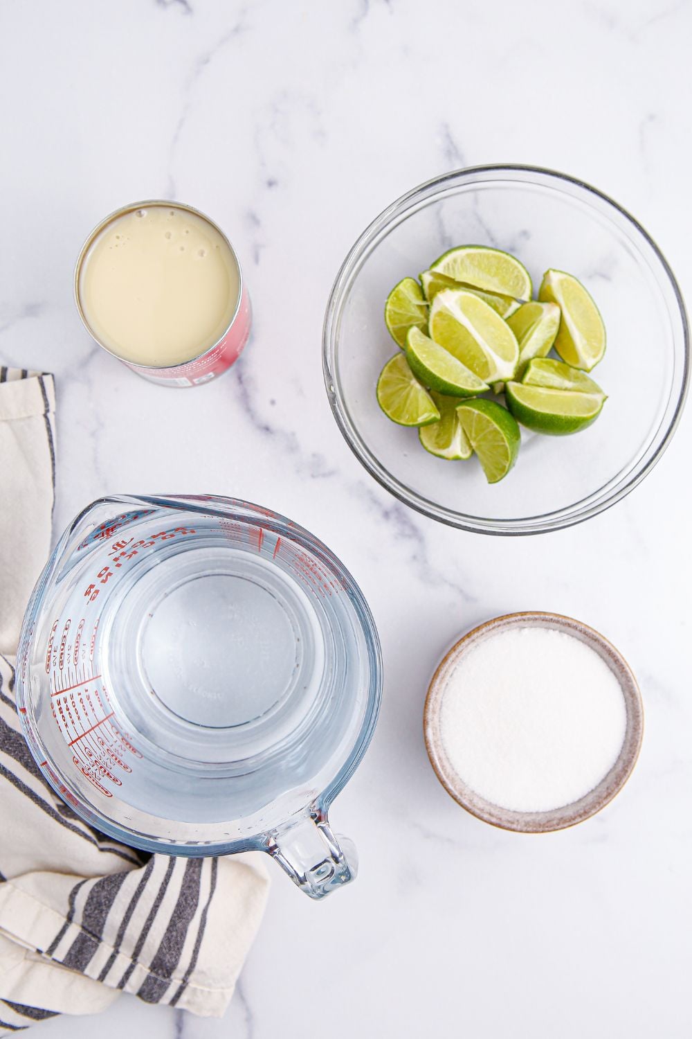ingredients for Brazilian Limeade sitting on marble counter
