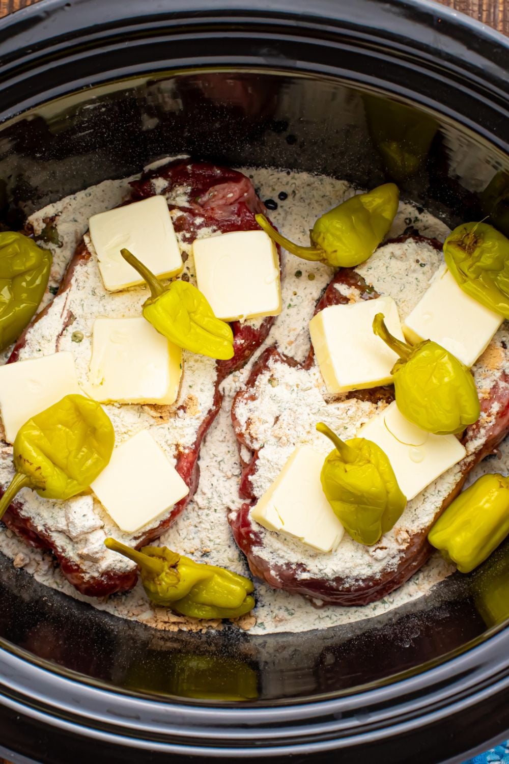 peppers and buter over Slow Cooker Mississippi Ribeye Steaks