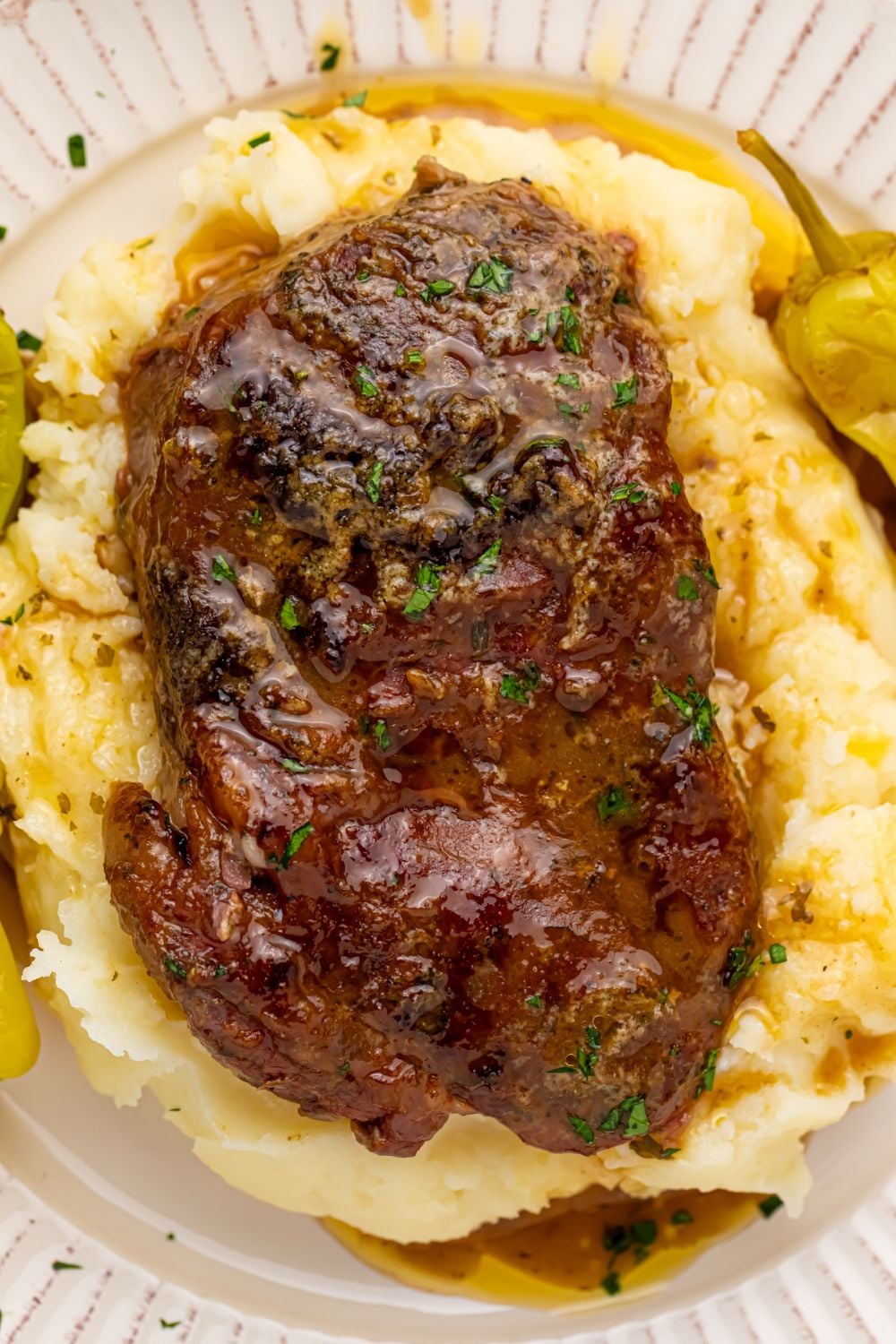 memphis rib eye on plate of mashed potatoes