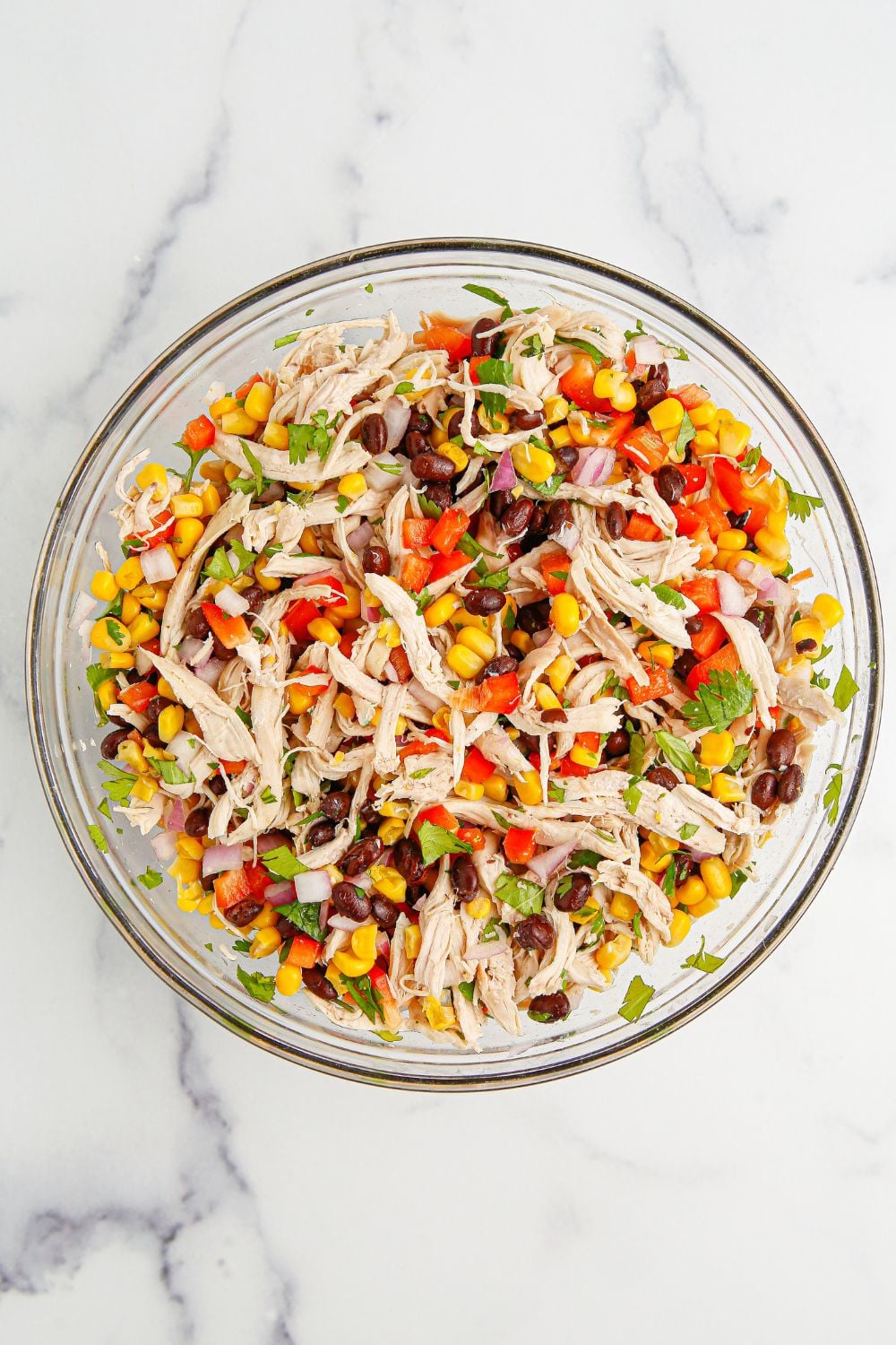 Southwest Chicken Salad ingredients tossed in a bowl that is slightly mixed up