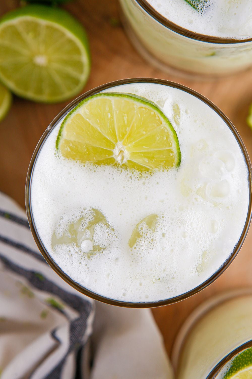 Brazilian Limeade in glass with overhead look to see the white creamy texture and a lime garnish