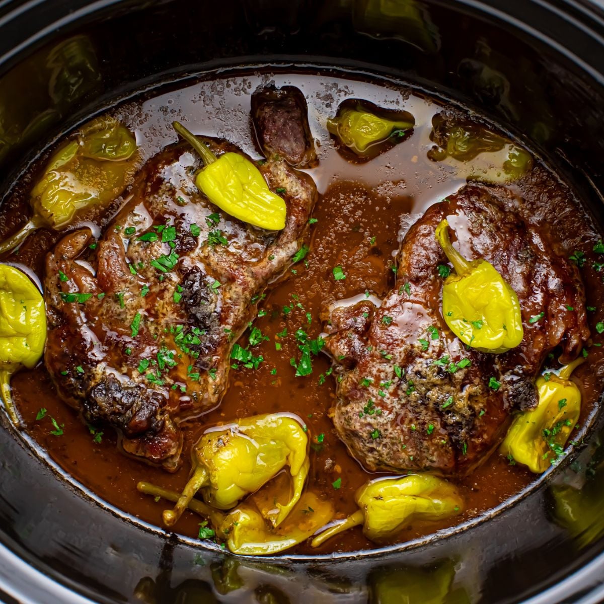 Slow Cooker Mississippi Ribeye Steaks in a slow cooker on table