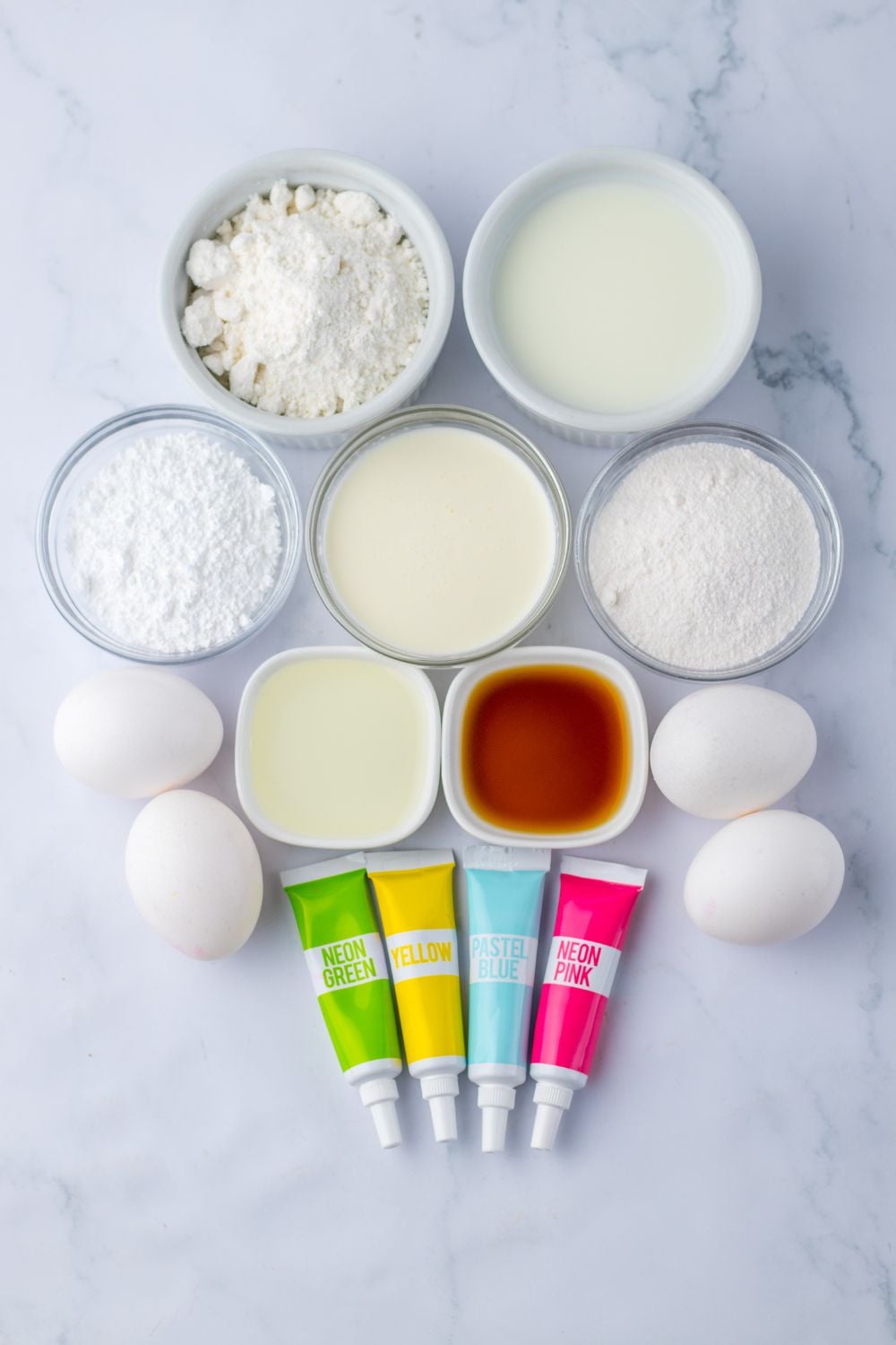 ingredients for the Easter Poke Cake in single serve bowls on table
