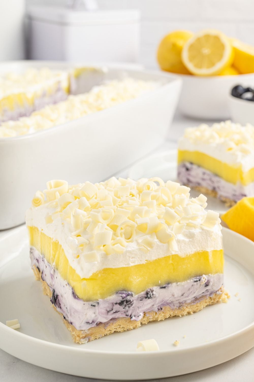 slice of blueberry delight on plate wih more slices around it on table