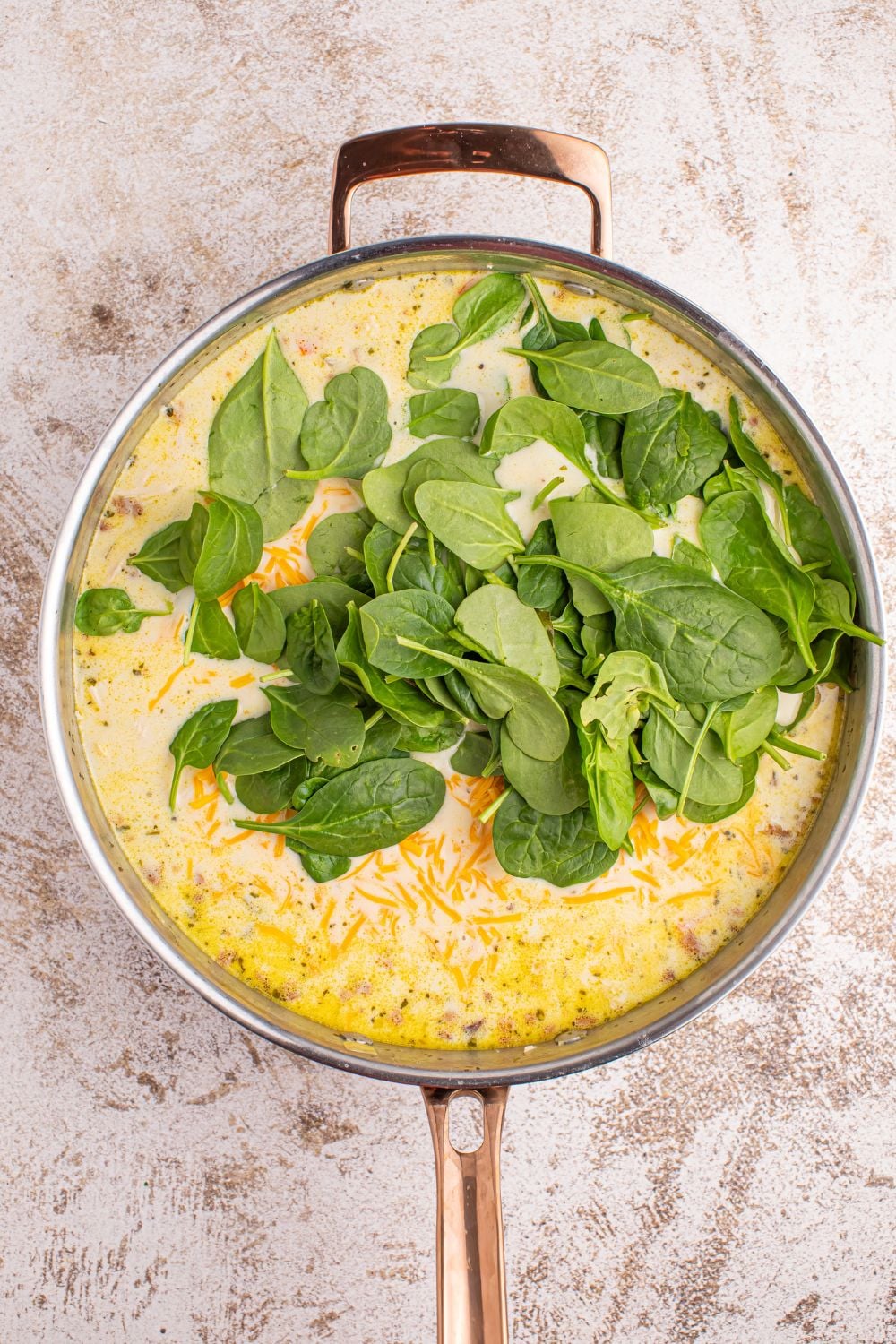 spinach poured into pan of Crack Chicken Soup in it