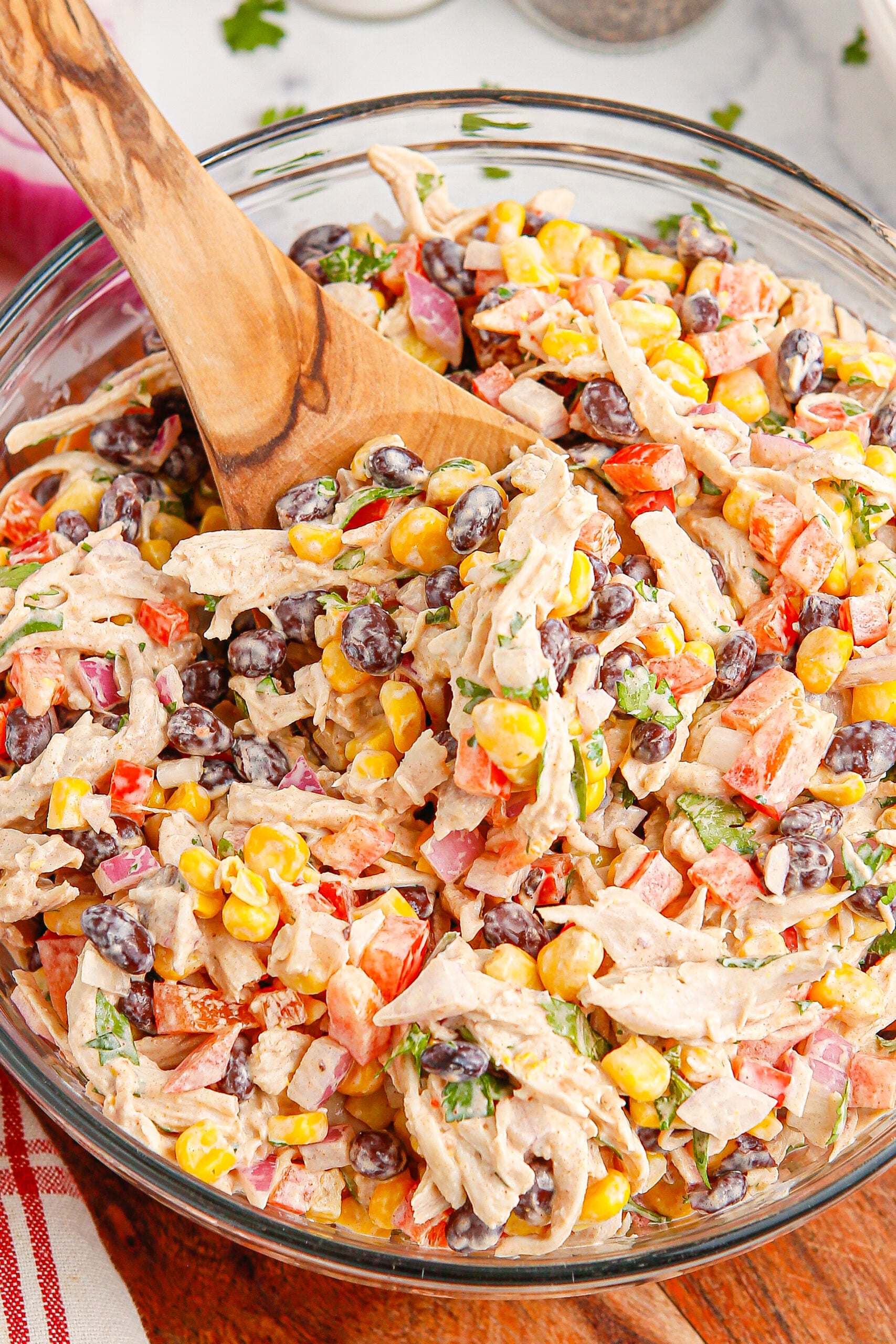 Southwest Chicken Salad in a bowl with a wooden spoon in the bowl