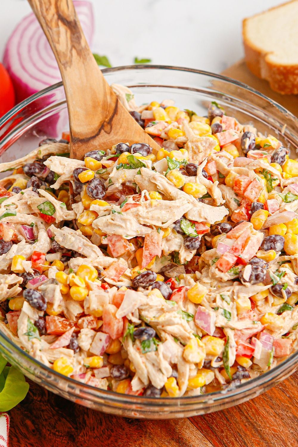 Southwest Chicken Salad in a bowl with a wooden spoon in the back side of bowl