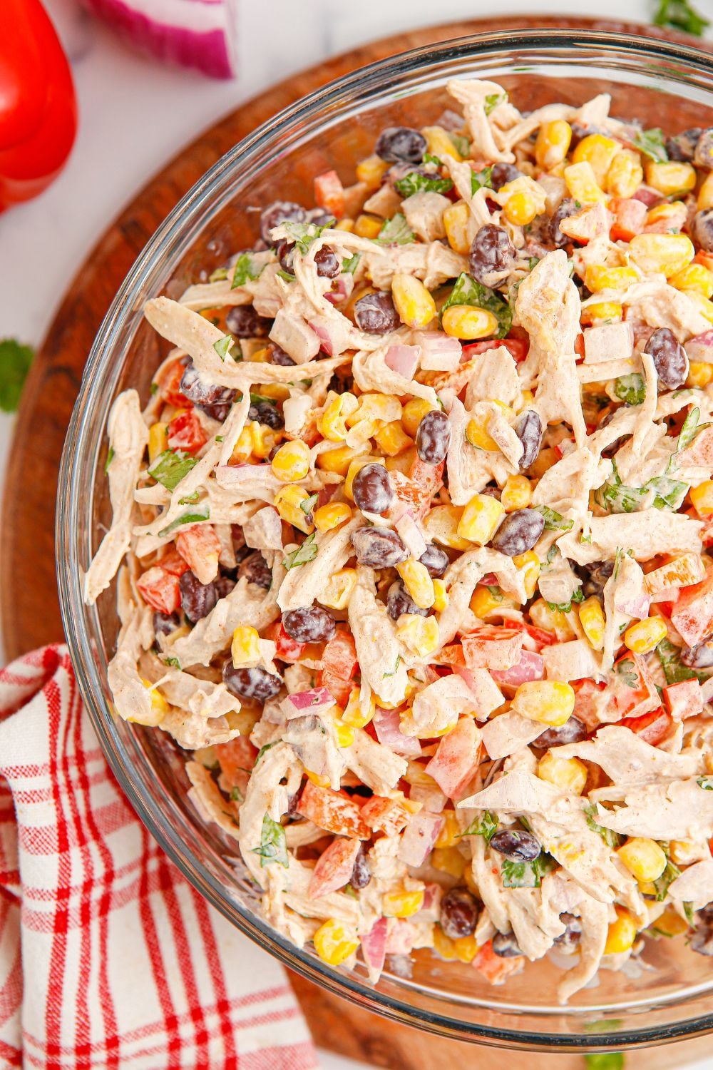 Southwest Chicken Salad in a bowl with tomatoes on table and a red striped towel