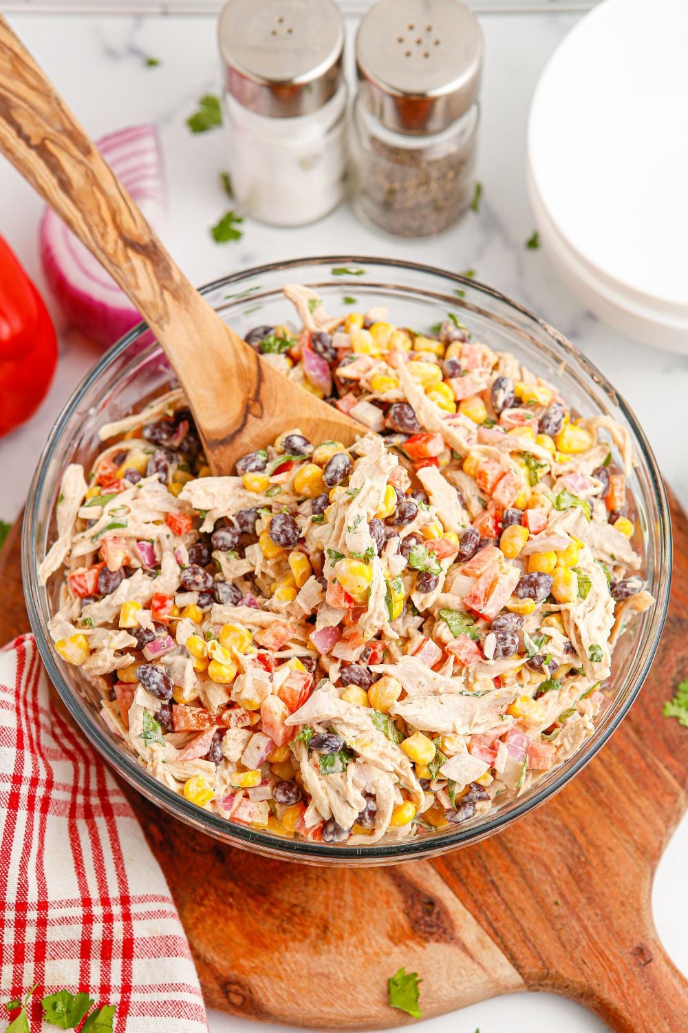 southwest style salad in a bowl with salt and pepper shakers sitting on table