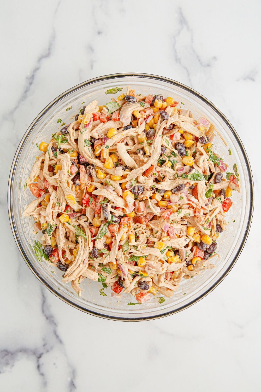 Southwest Chicken Salad mixed up and sitting on the table in a glass bowl