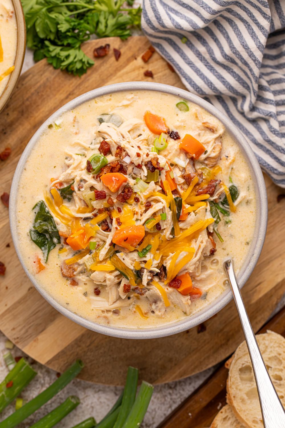 ovrhead look of Crack Chicken Soup in a bowl with a spoon on the side. The bowl is sitting on table