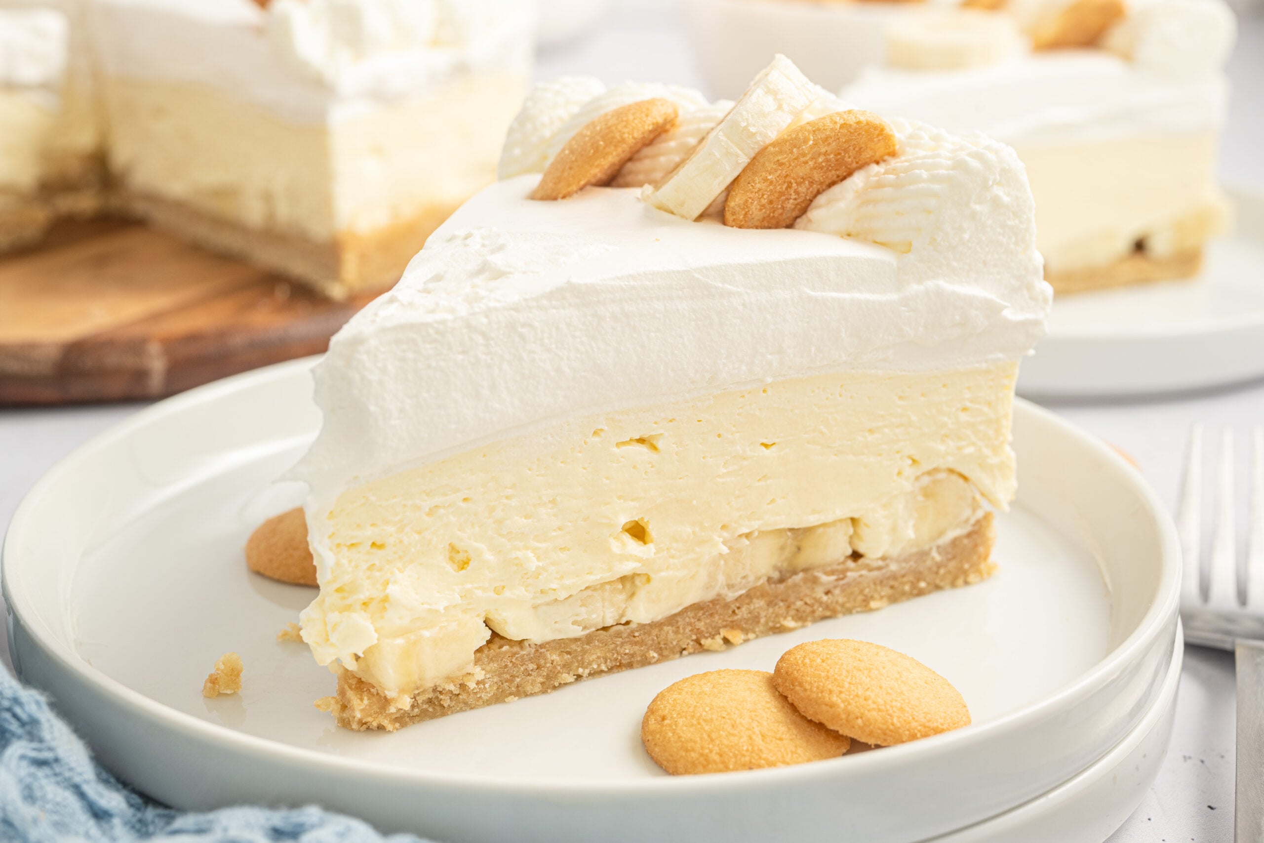 view of a banana pudding cheesecake sliced on white plates
