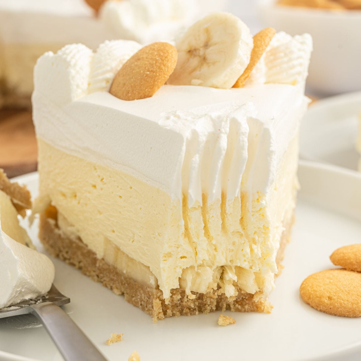 No Bake Banana Pudding Cheesecake on plat with a fork bite taken out of the slice