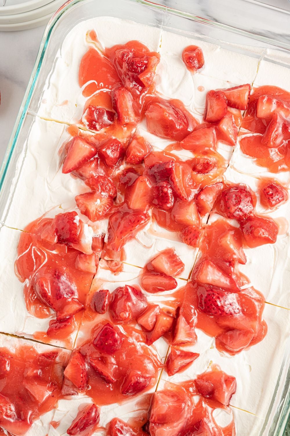 angel food cake strawberry dessert in a cake pan sitting on marble table