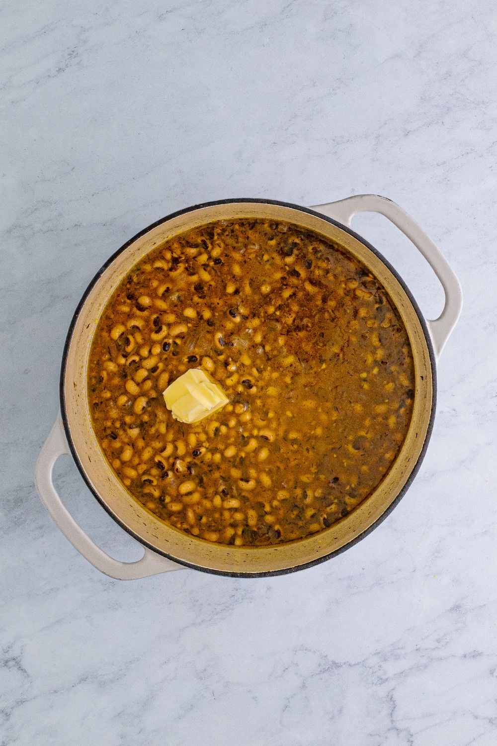 Black Eyed Peas with a slice of butter on the top of the peas 
