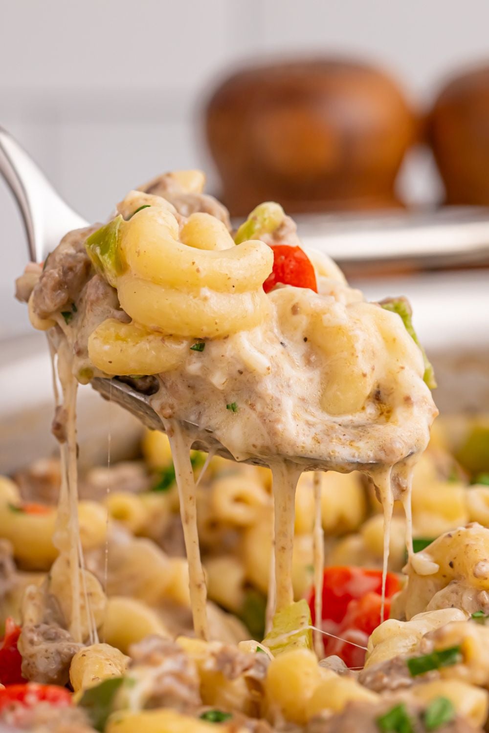 spoon above pan full of Philly Cheesesteak Pasta