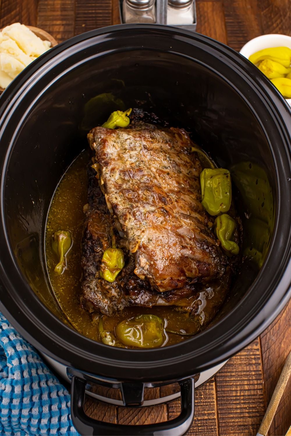 baby back pork ribs cooked and sitting in a slow cooker on the table