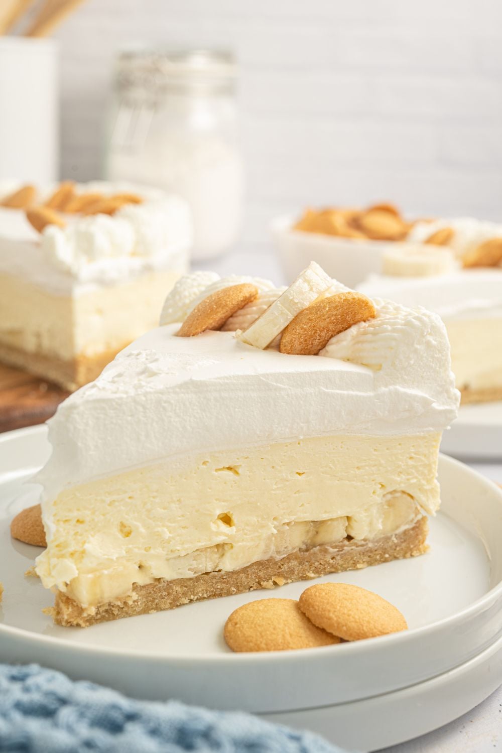 close up of banana cheesecake on table with wafers around it.