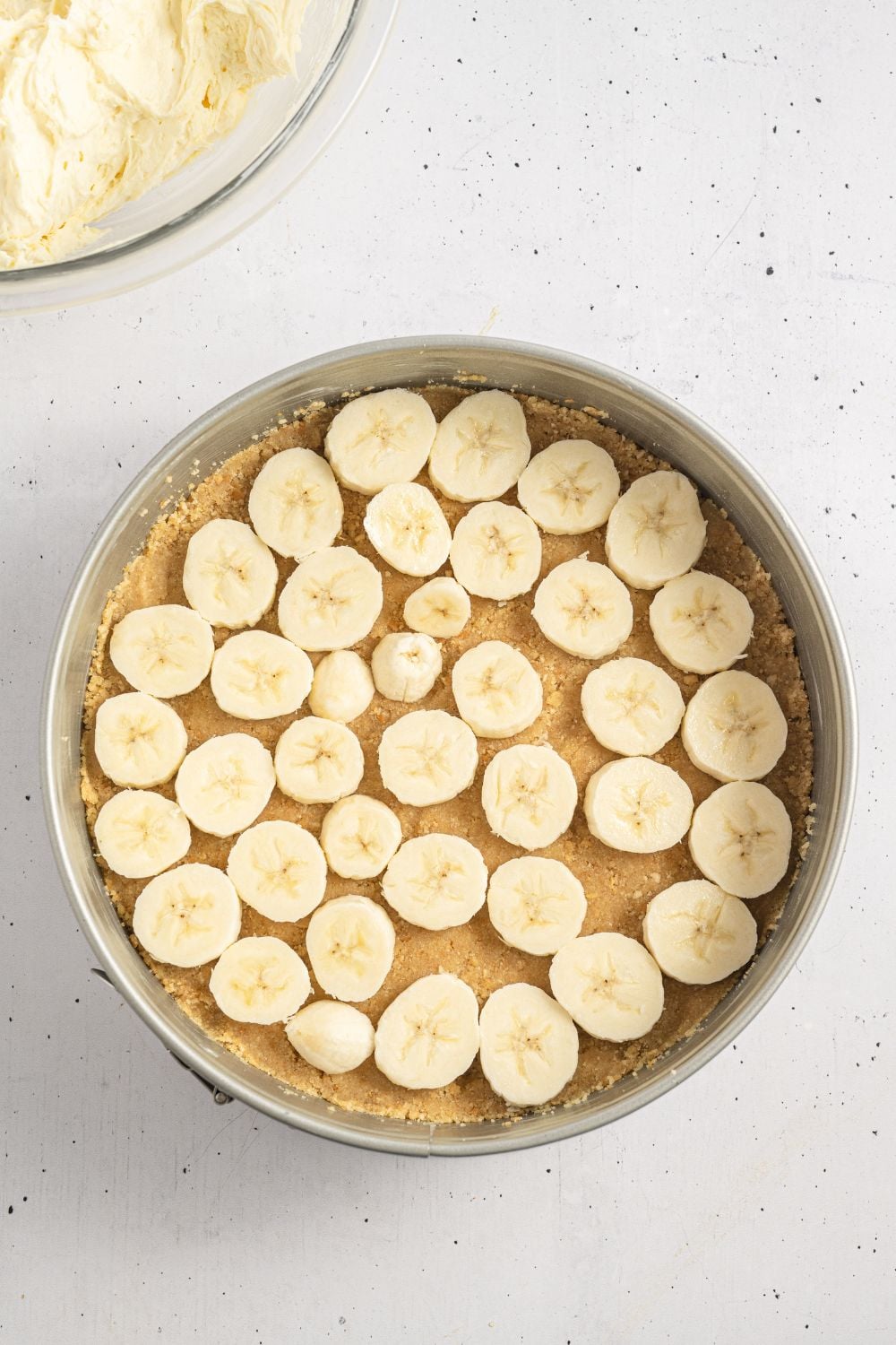 vanilla wafer crust in a springform pan with sliced bananas on top