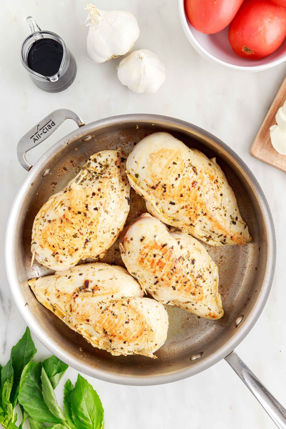 partially cooked Caprese Stuffed Chicken in a skillet 