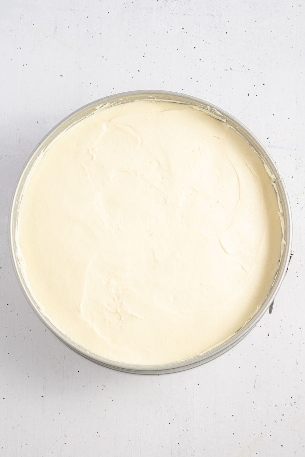 banana pudding cheesecake in a springform pan on table