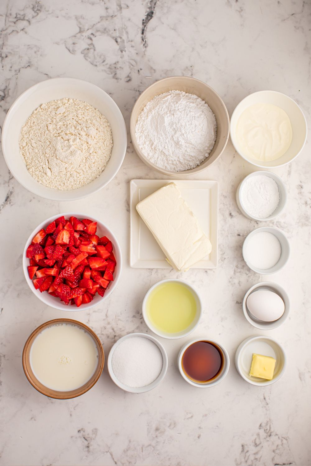 ingredients for Strawberry Cheesecake Pancakes in single serve bowls on marble table