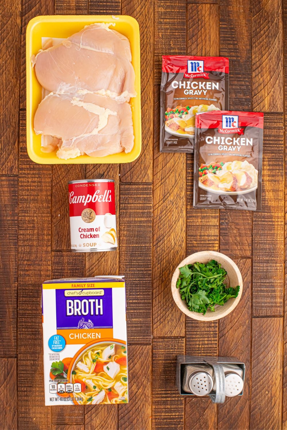 ingredients for Crock Pot Chicken and Gravy items sitting on a wooden table 