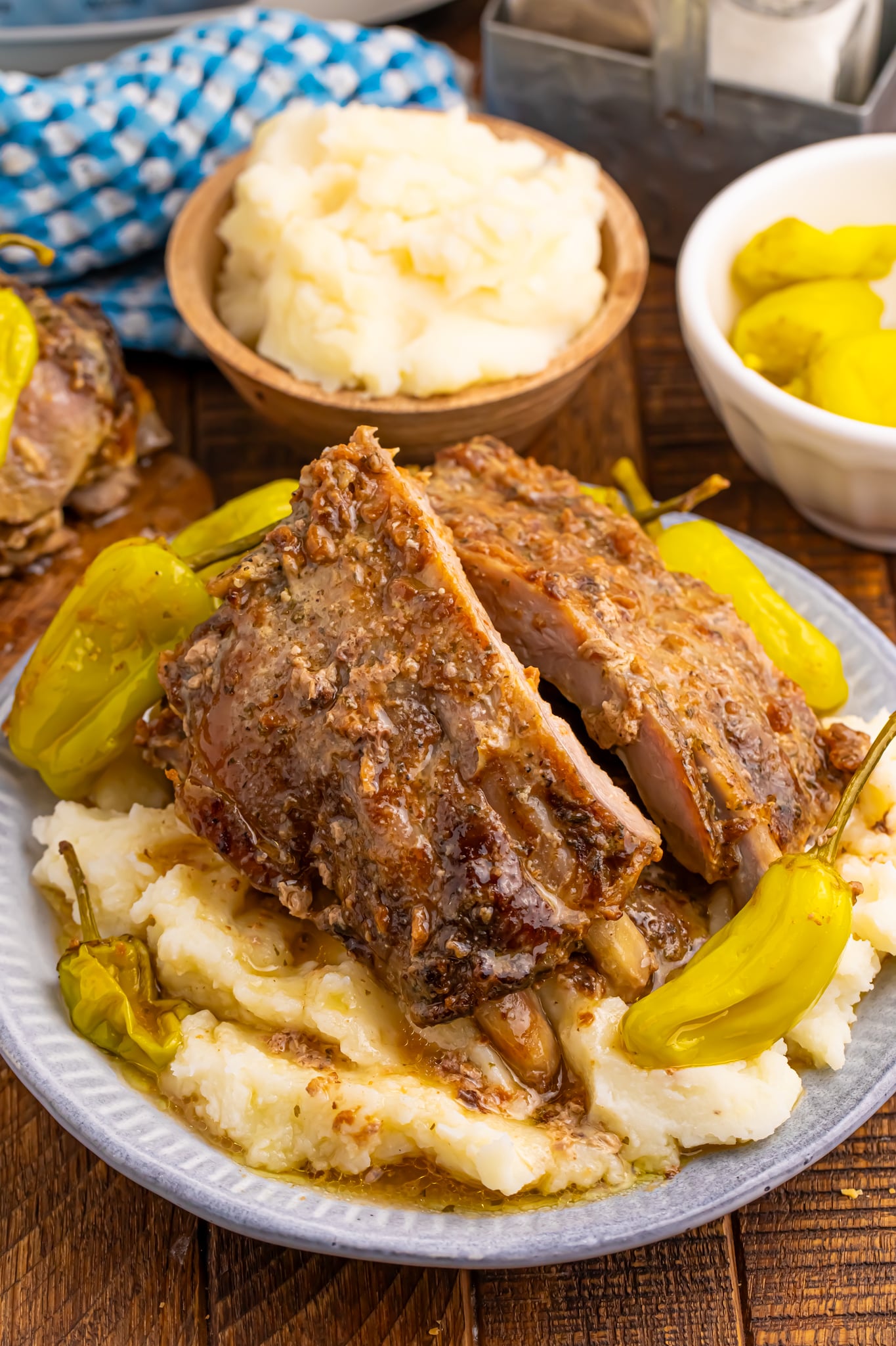 Slow Cooker Mississippi Ribs on a white plate sitting on top of mashed potatoes