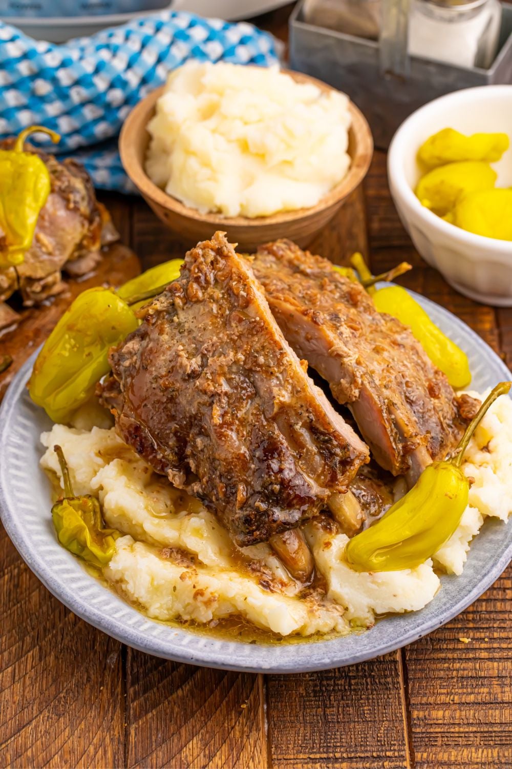 plate with mashed potatoes, mississippi ribs, peppers and more.