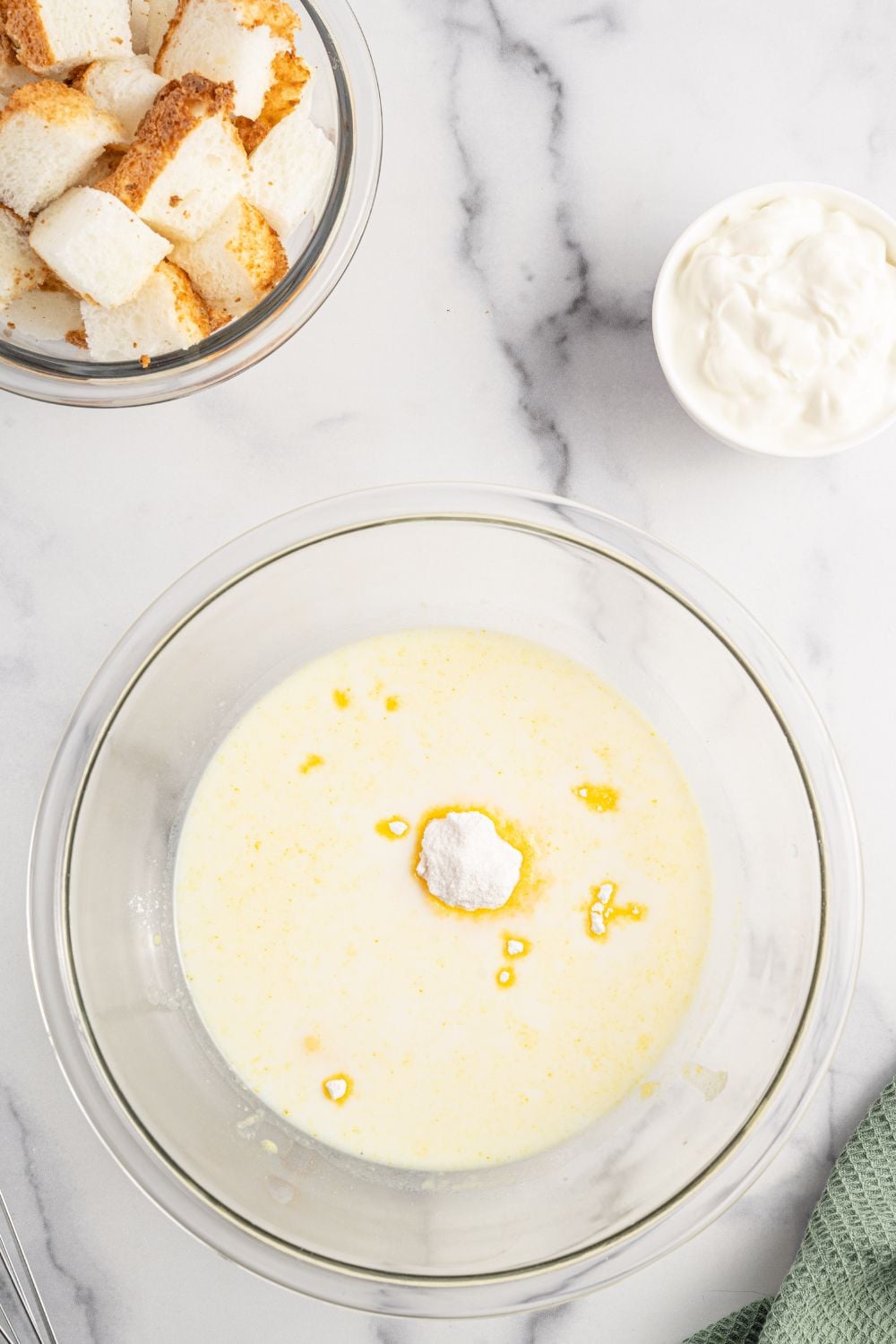 vanilla pudding mix poured in a bowl with milk for making the Strawberry Heaven On Earth Cake