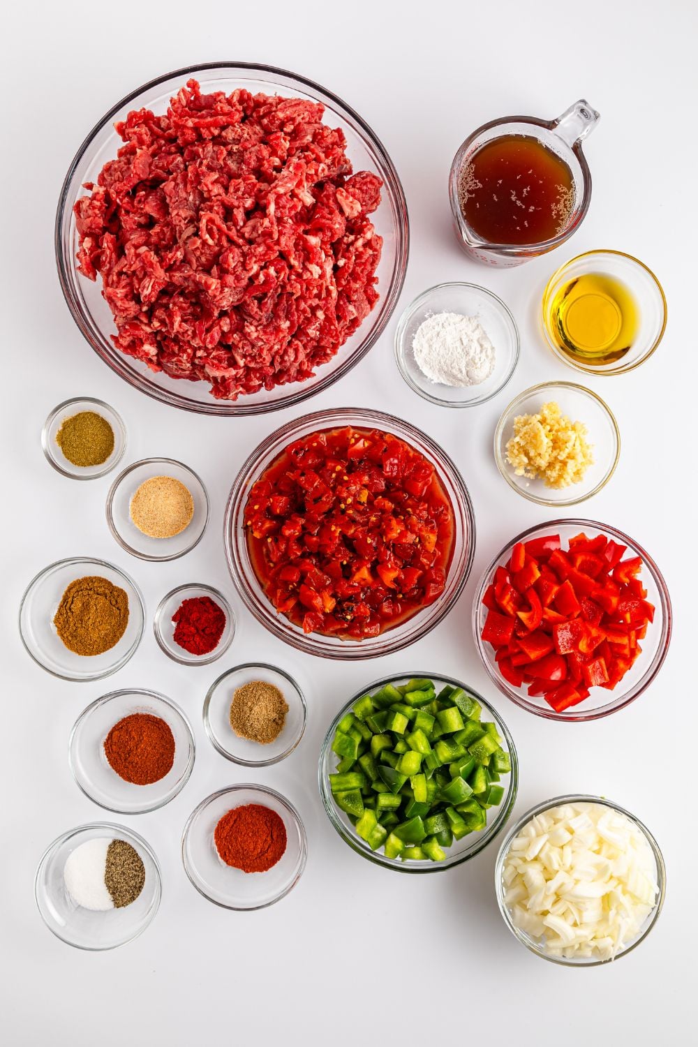 ingredients of carne picada in small bowls on table to showcase each ingredients