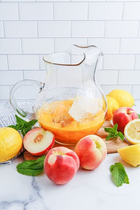 peach concentrate in a large picture with ice and fresh peaches and lemons around it