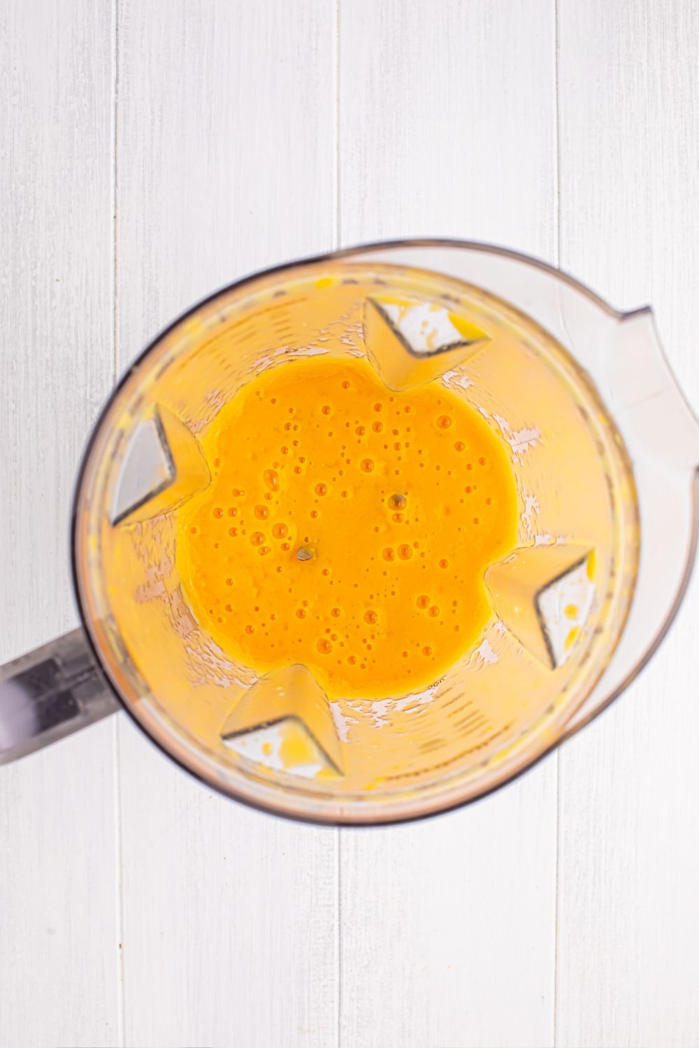 blender with a peach mixture blended up