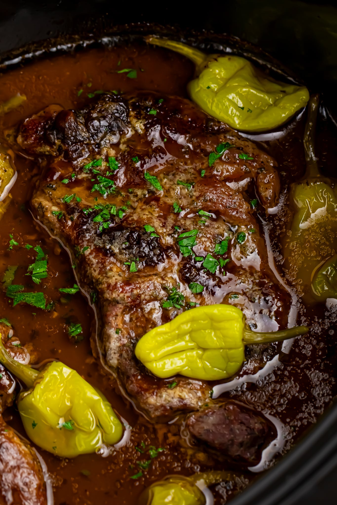 Slow cooker Mississippi ribeye steaks up close shot in a crockpot to show texture