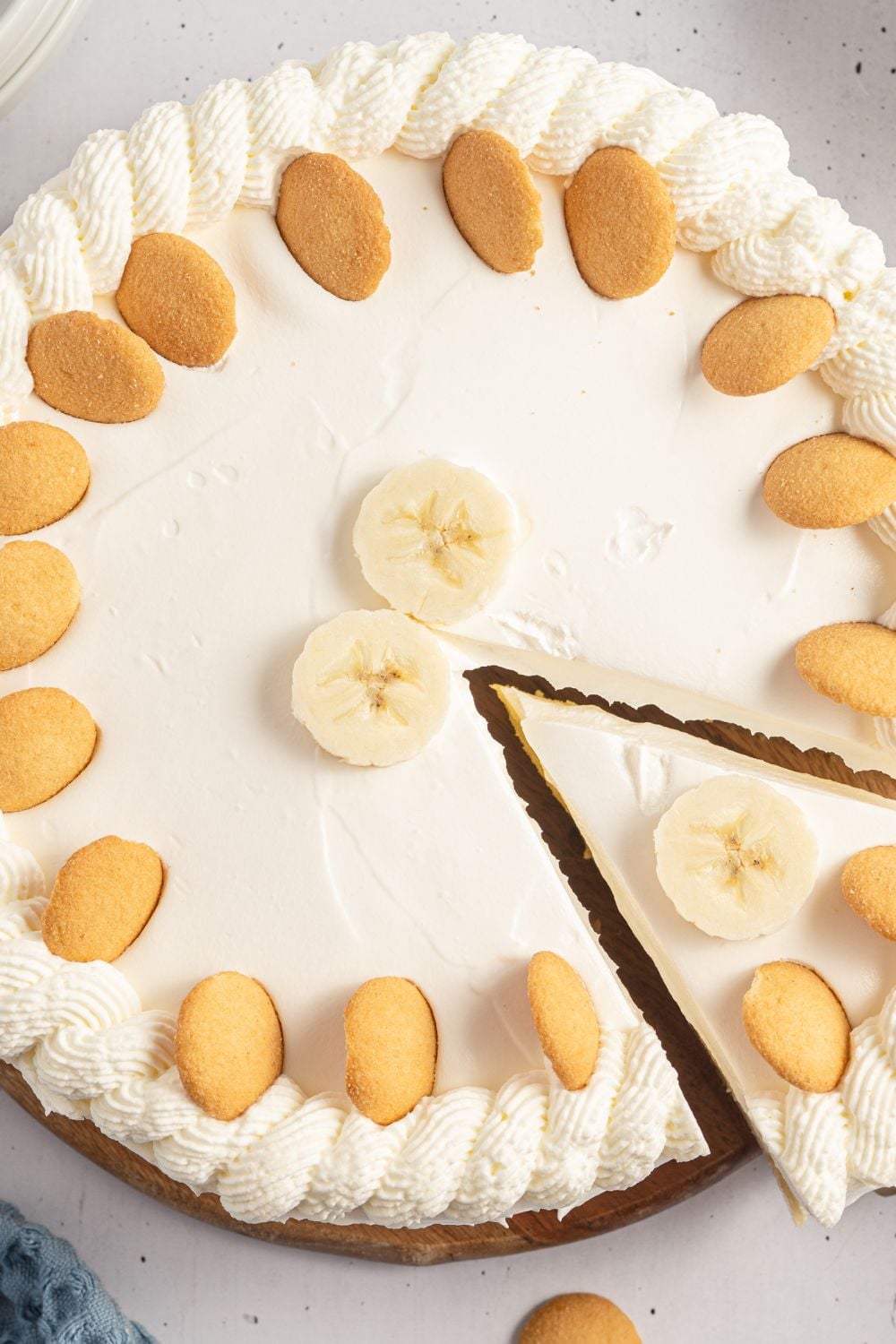whole banana cheesecake on table with one slice cut